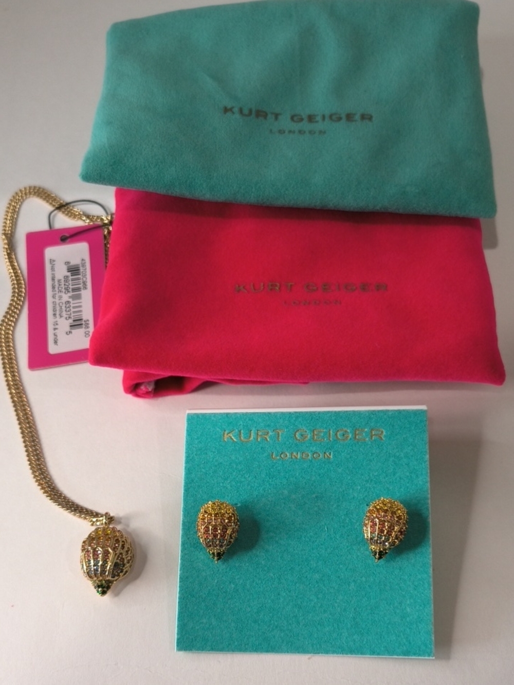 Kurt Geiger Gold Eagle HeadNecklace and Stud Earrings with Pink and Teal Pouches
